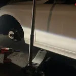 Mobile tyre fitter replacing a flat tyre at the roadside in London & the South East