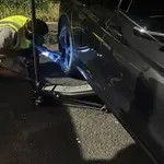 Mobile tyre fitter replacing a flat tyre at the roadside in London & the South East