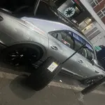 Mobile tyre fitter replacing a flat tyre at the roadside in London & the South East