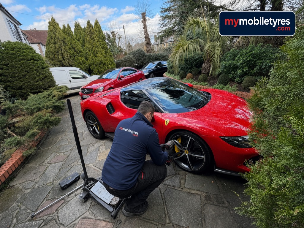 Mobile tyre fitter working on a car tyre in London & the South East